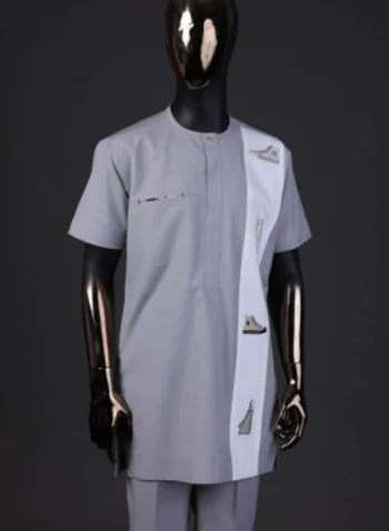 A pewter grey front flap with gold Swarovski button detailing and side all-stars embroidery detailing on white kaftan and Sokoto